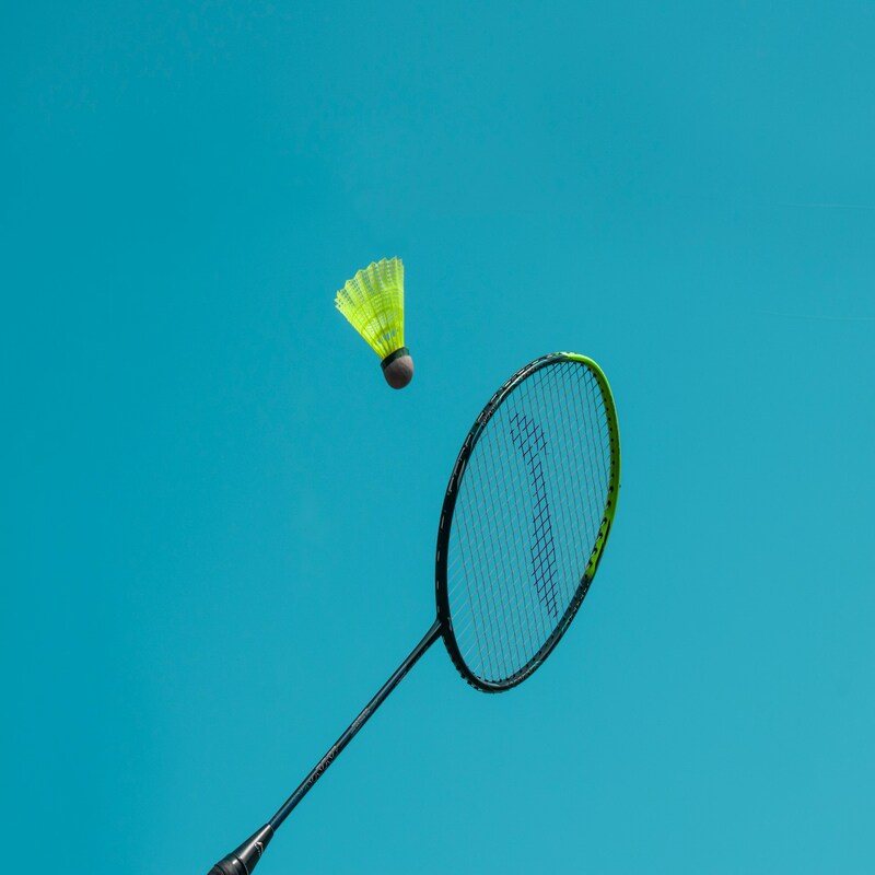 Beginner badminton player on court in Australia — shop lightweight Yonex racquets for new players and juniors